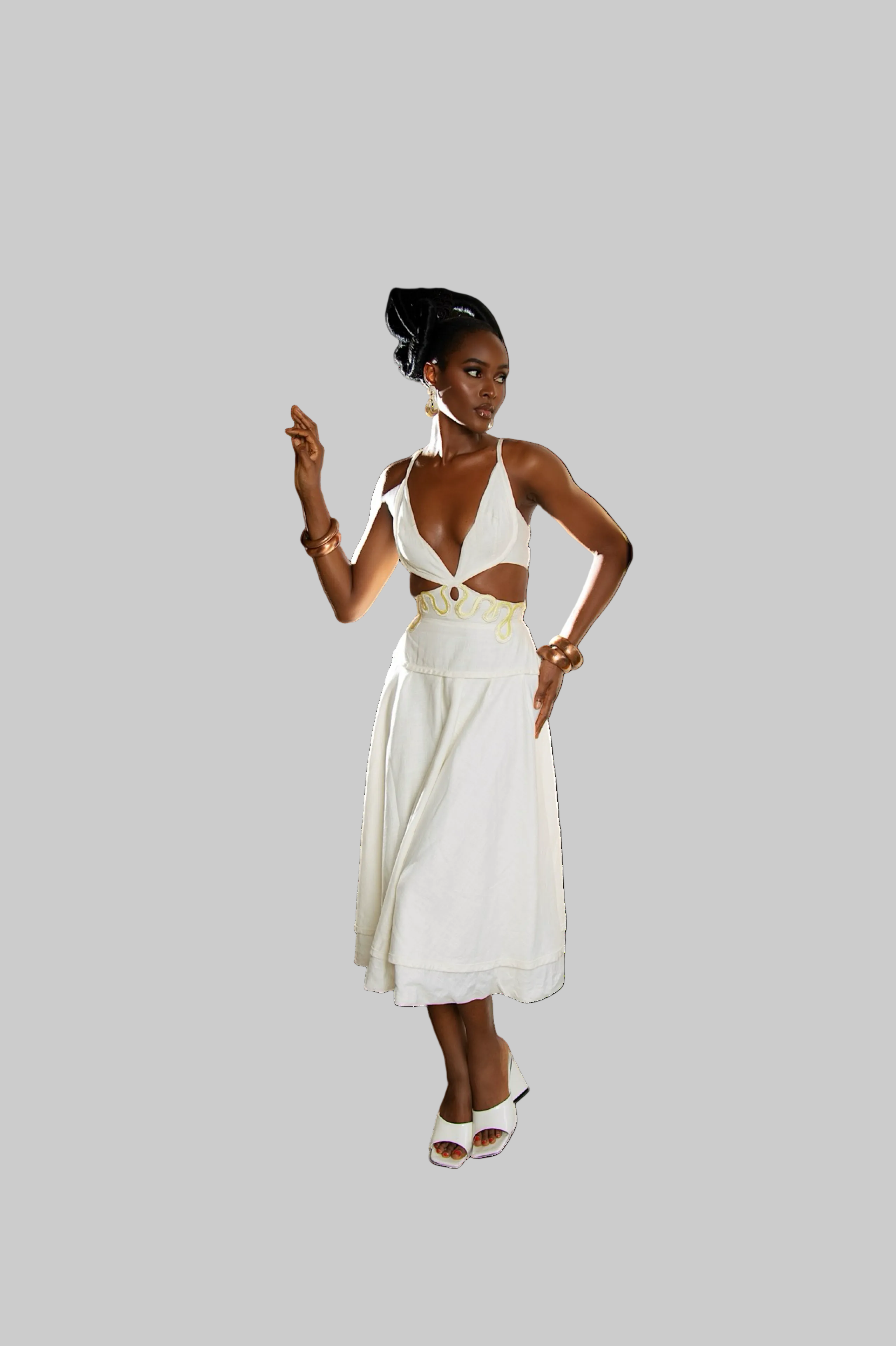Woman wearing a white dress with a gold belt on a white background