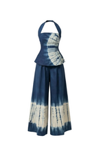 Tie-dye outfit with halter top and wide-leg pants on a white background